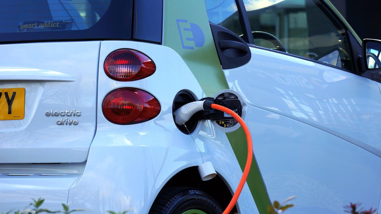 Close-up of an electric car being charged, highlighting eco-friendly transportation.